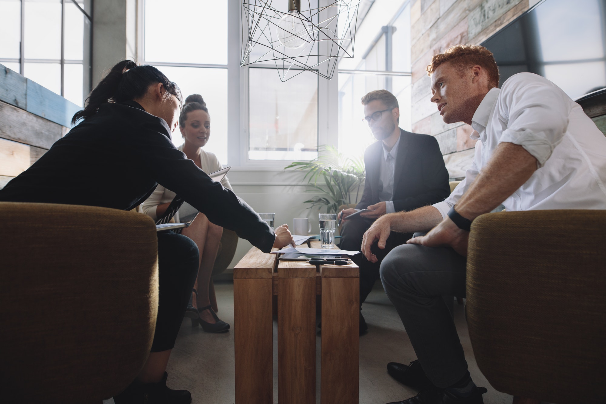 Business colleague sitting at table during corporate meeting